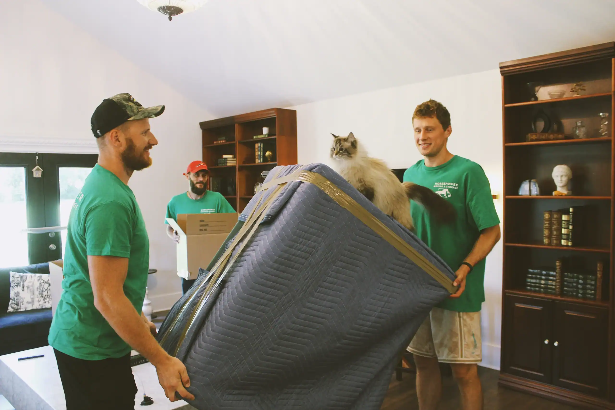 Horsepower Moving crew carrying protected furniture during a residential move in Louisville, KY